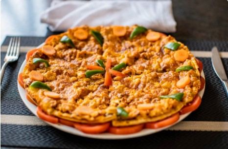 Freshly baked pizza served with tomatoes