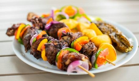 Grilled meat skewers with vegetables and potatoes