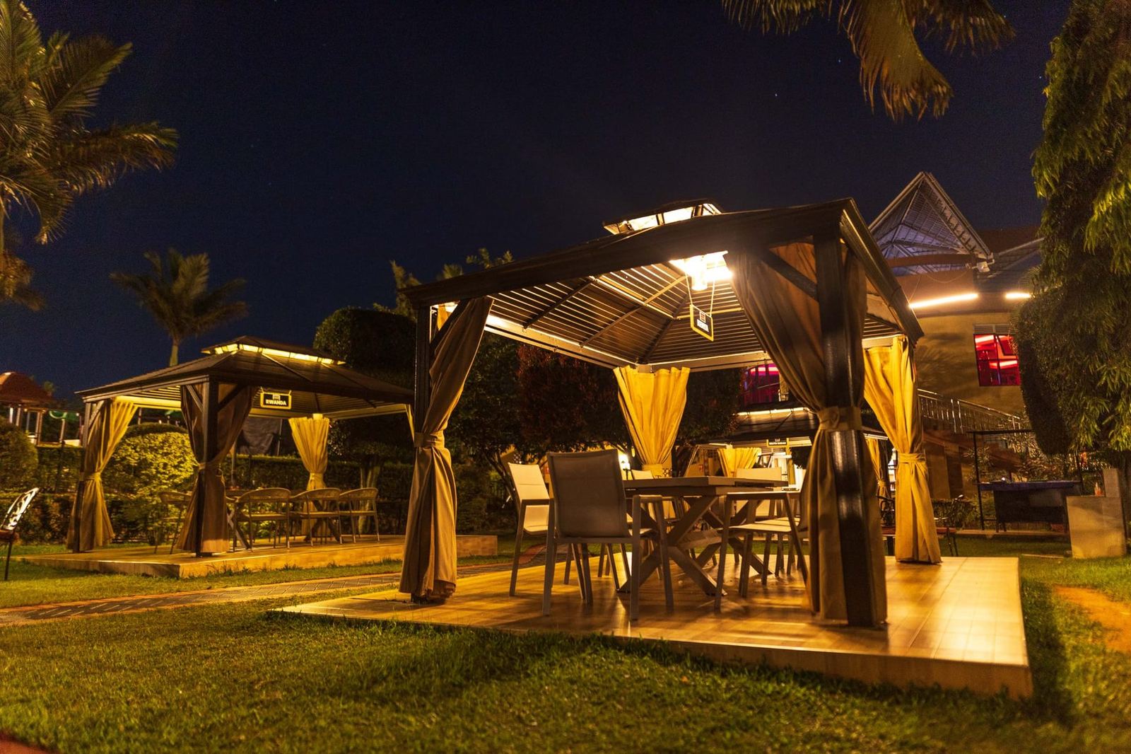 Garden gazebo dining area lit up at night